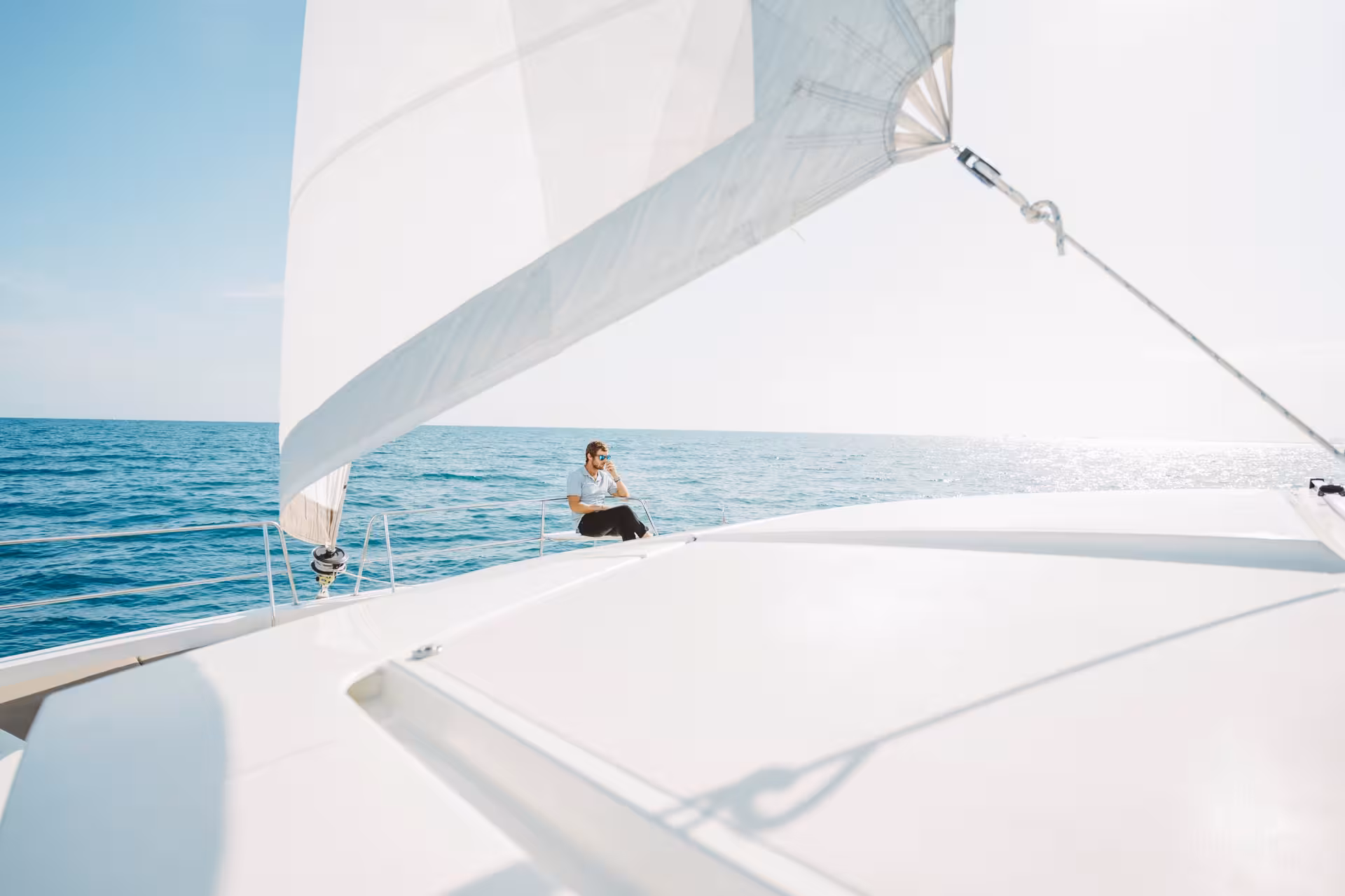 Relaxing on the bow of a Bali 4.1 luxury catamaran during a 4-hour private sailing tour in Barcelona