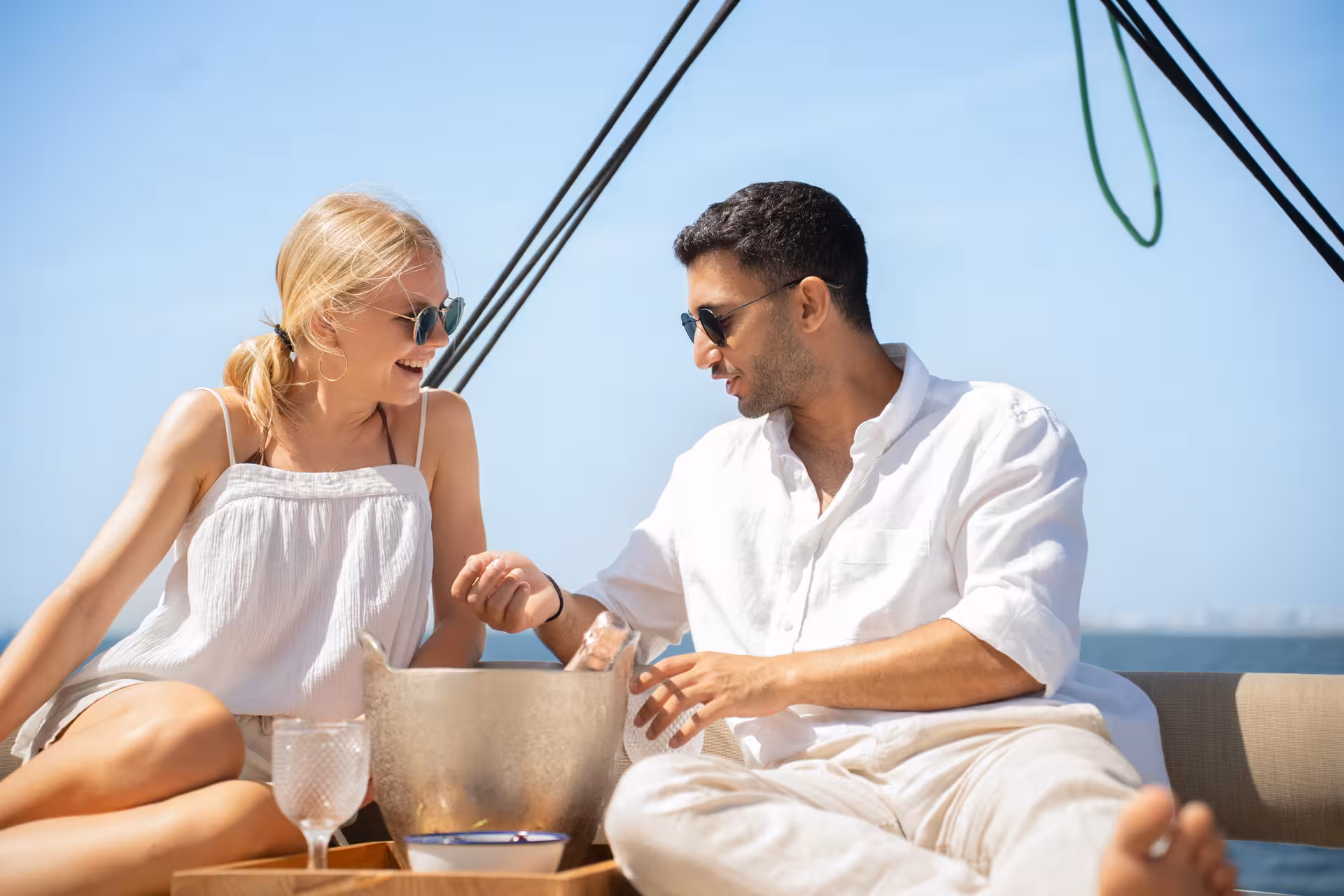 Couple enjoying drinks on a private luxury catamaran in Barcelona, Bali 4.2 charter with sea views