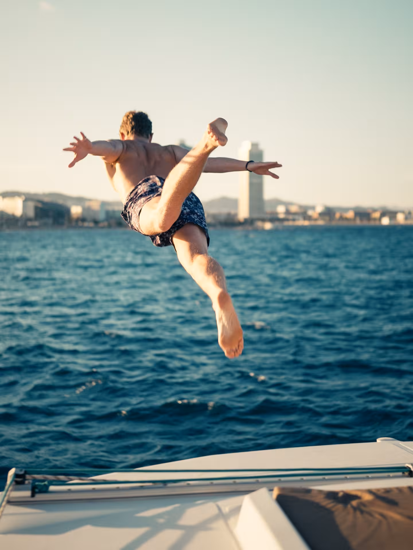 Guest diving into the Mediterranean from a private Bali 4.1 luxury catamaran on a 3-hour Barcelona charter