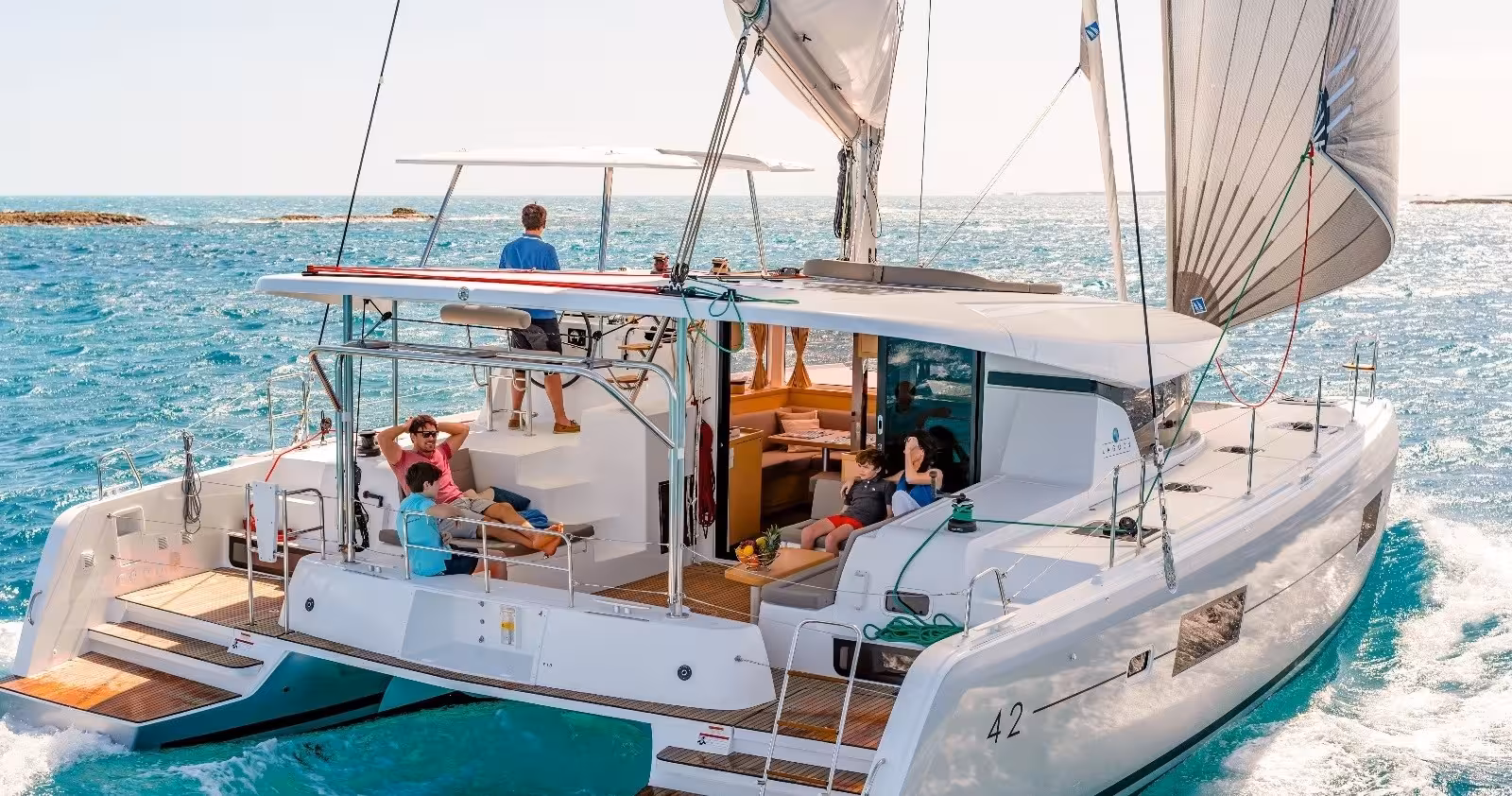 Family relaxing on luxury catamaran deck during VIP private sailing tour in Lisbon on the Tagus River