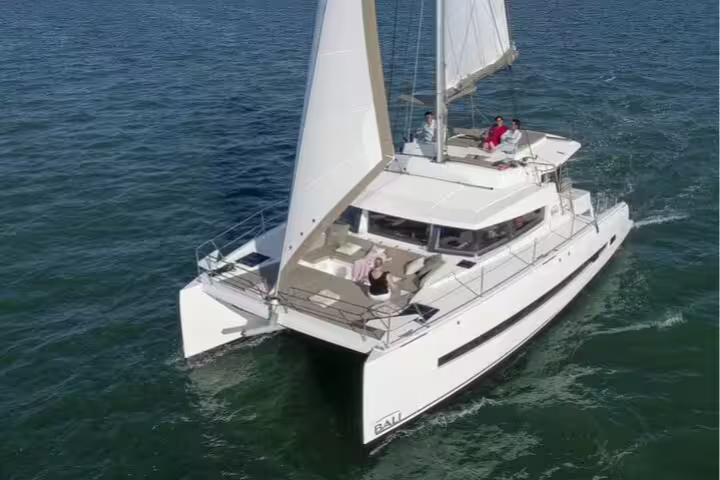 Luxurious catamaran sailing on the clear blue waters of Cyprus, offering an exclusive tour experience from Limassol.