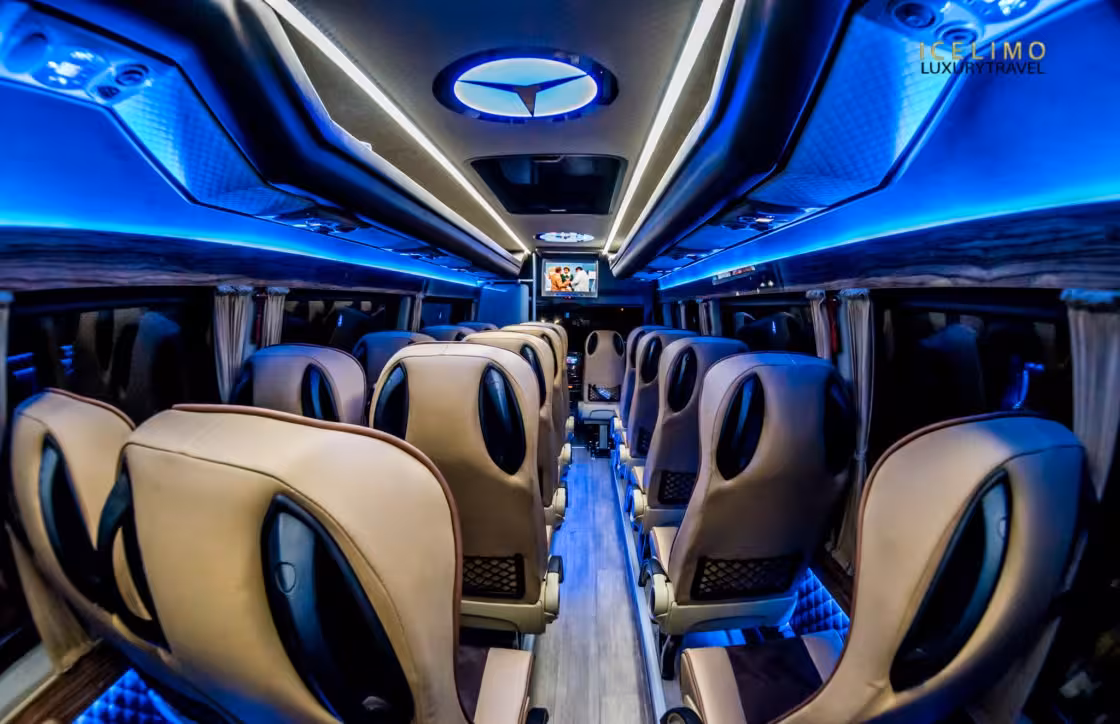 Luxury Mercedes coach interior with blue LED lighting and beige leather seats for private Iceland tours