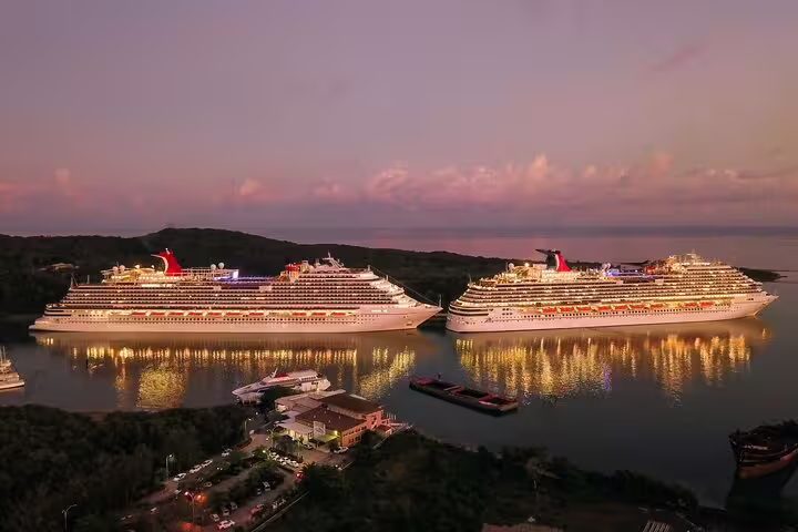 Two luxury cruise ships illuminated at sunset docked near Berlin, ideal for private airport transfer from SXF