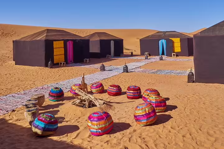 Luxury desert camp in Merzouga with colorful Berber seating, Morocco 11 day tour from Marrakech