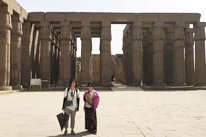 Travelers at Karnak Temple colonnade in Luxor, highlight of Cairo and Oberoi Philae Nile Cruise tour