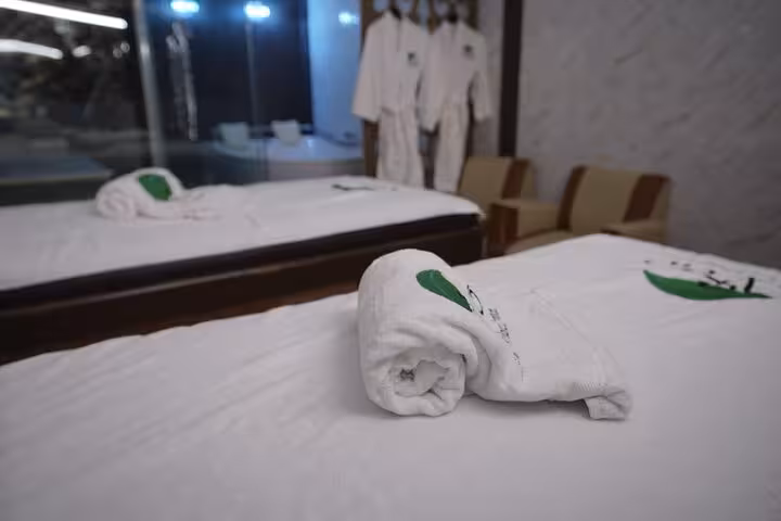 Private solo spa massage room in Sharm El Sheikh with treatment beds, towels and robes for luxury hammam