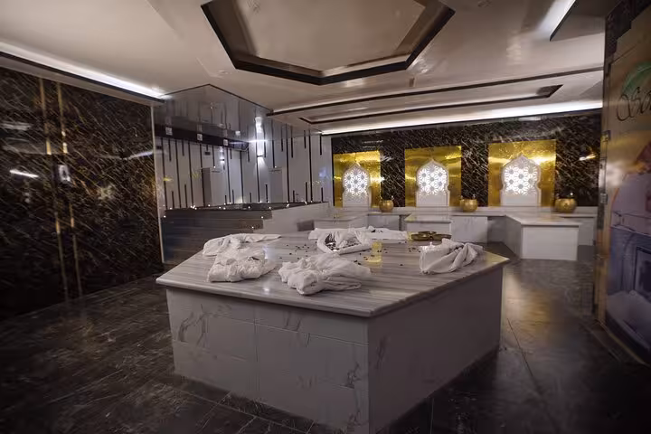 Luxury royal hammam room in Sharm El Sheikh with marble scrub table, warm lighting and spa towels