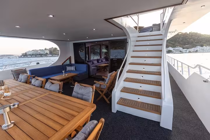 Luxury aft deck lounge and staircase on private Istanbul Bosphorus yacht cruise with panoramic sea views