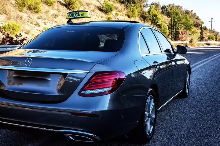 Luxury Mercedes-Benz sedan taxi on highway for private transfer service