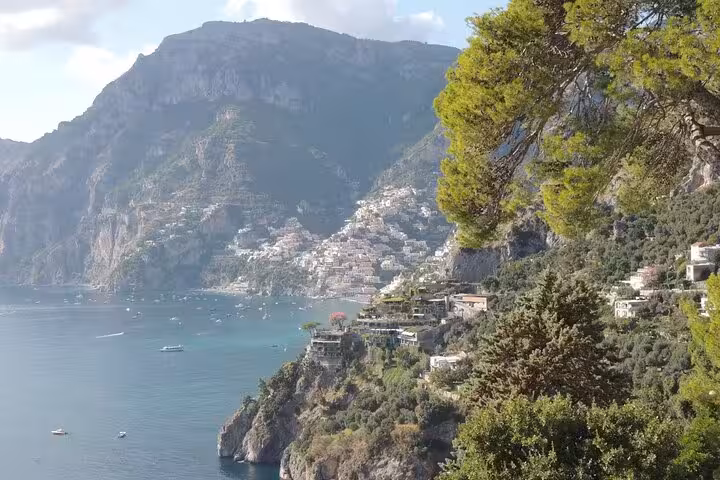 Luxurious black Mercedes van ready for private transfer service from Positano to Rome, parked outside elegant building.