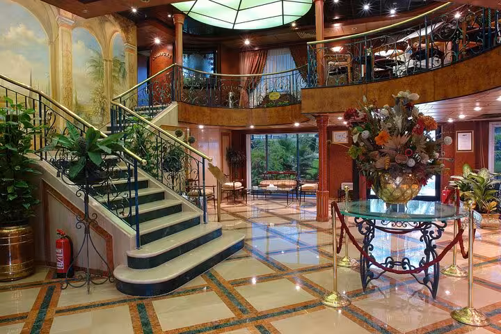 Luxury Nile cruise ship lobby with grand staircase, ideal for 5-day Luxor to Aswan Egyptian treasures cruise