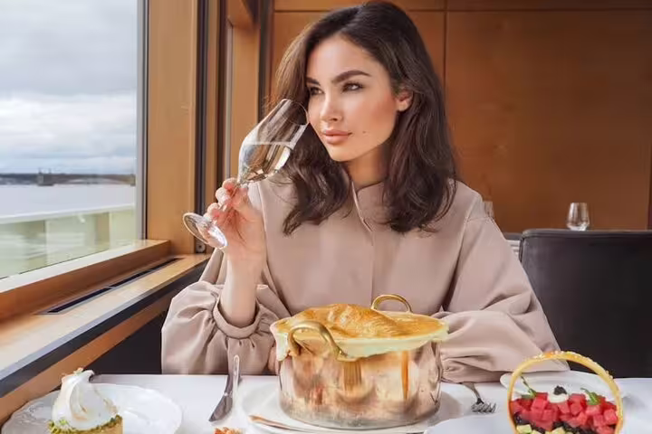 Fine dining by the window on Luxury Cairo Nile dinner cruise, elegant meal and drinks on Nile Maxim