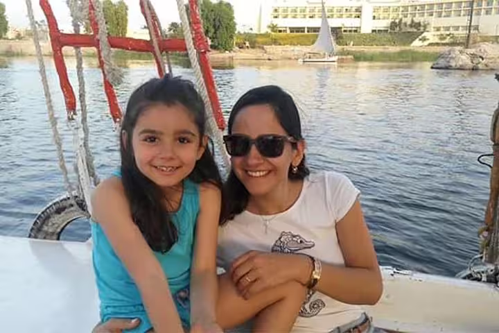 Family relaxing on a Nile felucca in Cairo, part of Luxury 8-day Cairo tour and Oberoi Philae Nile Cruise