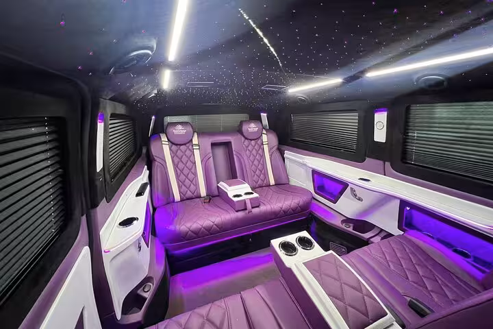 Luxury VIP van interior with ambient LED lighting and plush seats for private car tour and driver hire