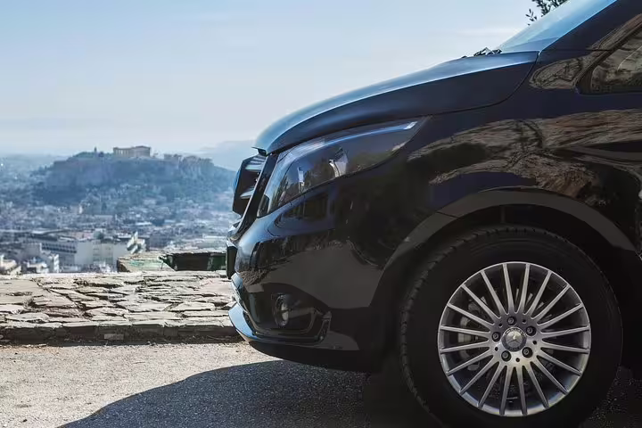 Luxury private tour van in Athens with city view backdrop, ideal for Best of Athens full day private tour