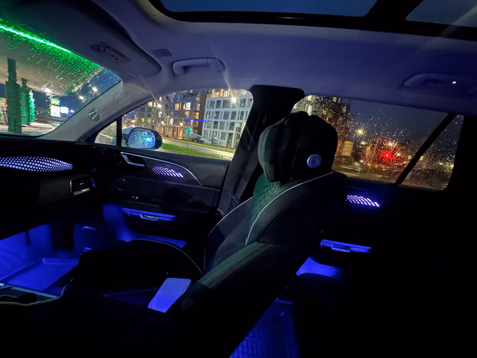 Luxury private transfer car interior with blue ambient lighting at night in Reykjavik