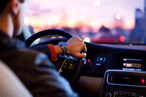 Professional driver in suit operating luxury car during private transfer service between Naples and Caserta, Italy