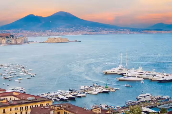 Driver opening luxury car door for private transfer from Naples to Salerno, comfortable door-to-door service