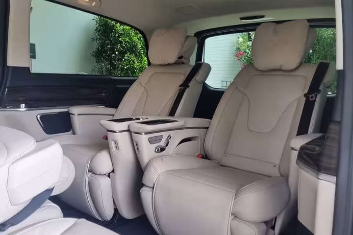 Luxury beige leather captain seats with center console in private van for Marseille tour