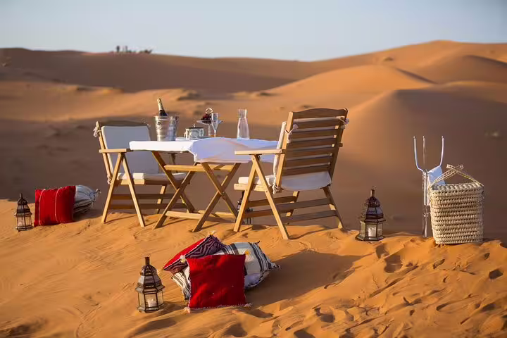 Luxury Sahara desert camp dining setup on Merzouga dunes, highlight of 9-day Morocco tour from Casablanca