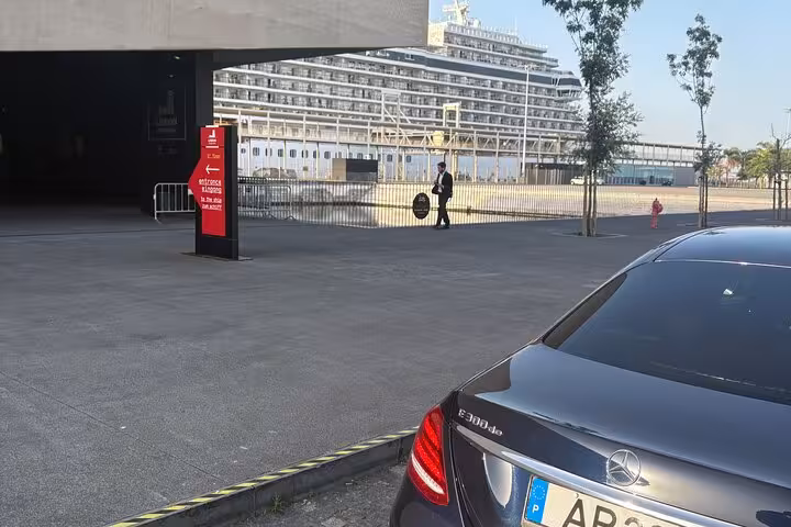 Luxury sedan at cruise terminal pickup area, premium transportation service for port transfers and private chauffeur