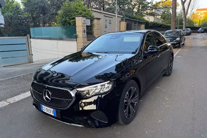 Luxury black sedan for private transfer from Fiumicino Airport to Rome with premium comfort and style.