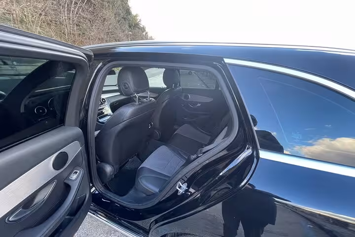 Spacious interior of luxury sedan for comfortable private transfer from Rome to Amalfi Coast.