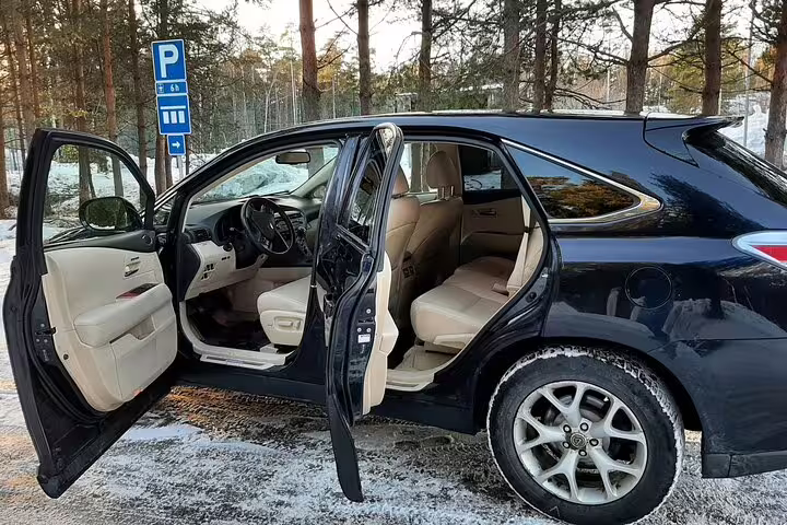 Luxury black SUV with open doors parked in snowy Norway for private Oslo Airport to Trysil transfer