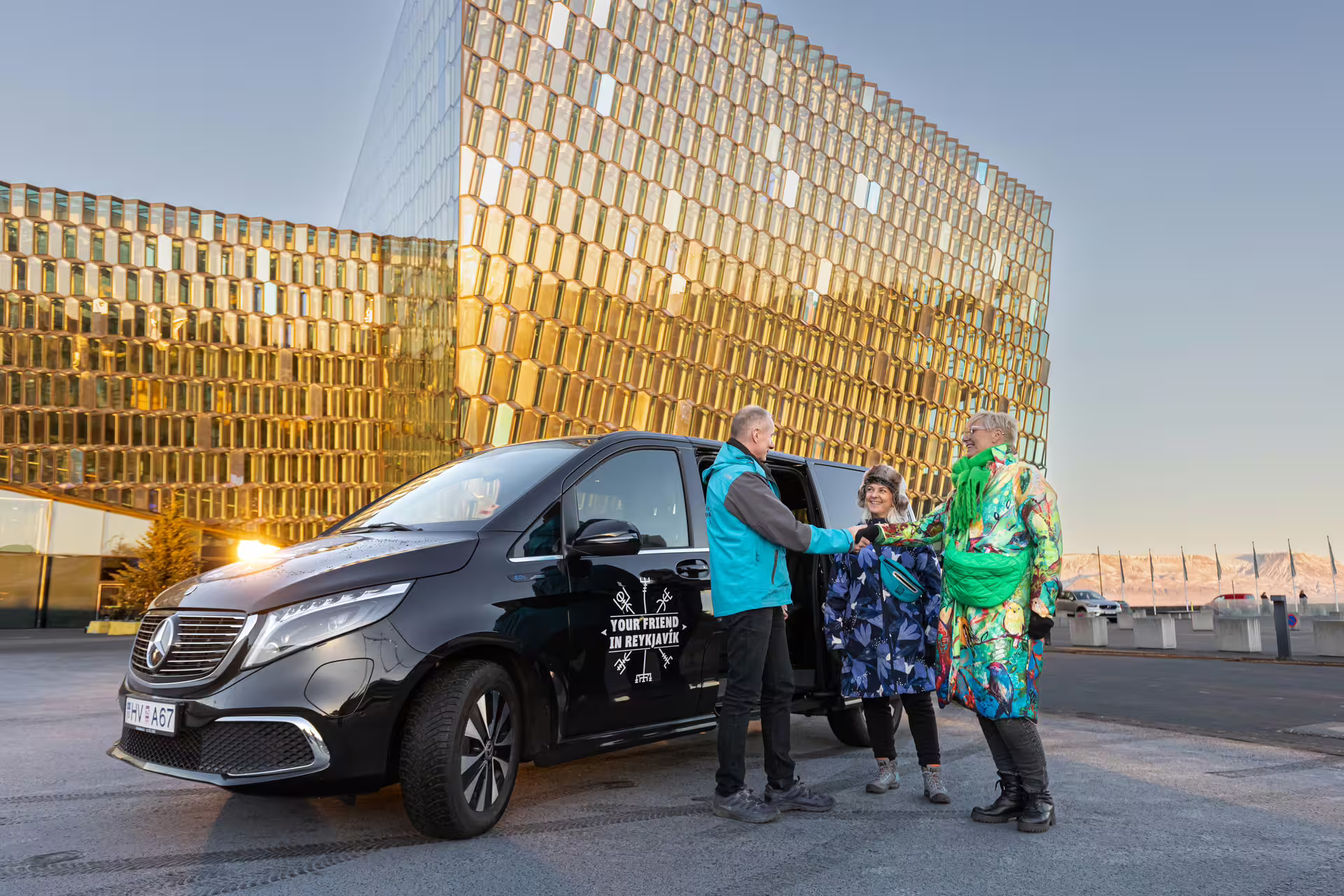 A picture of a Tour Vehicle from Your Friend in Reykjavik in front of the Harpa Concert Hall
