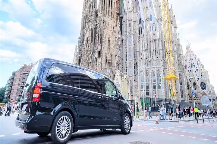 Luxury van parked near Sagrada Familia in Barcelona, showcasing highlights of the Barcelona City and Sitges Tour.
