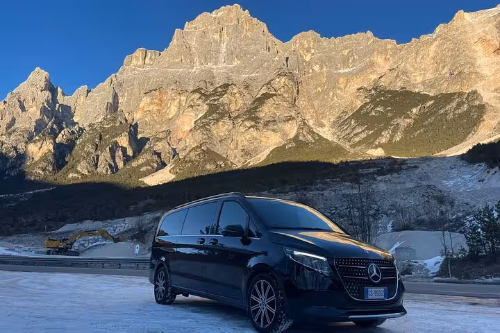 Luxury van parked against the stunning backdrop of the Dolomites, perfect for a day trip from Venice.