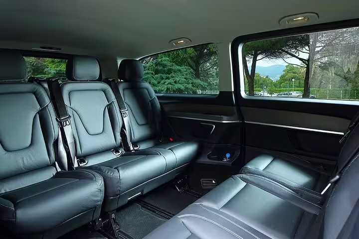 Luxury van interior with black leather seats and seatbelts for private tour from Marseille to Cassis