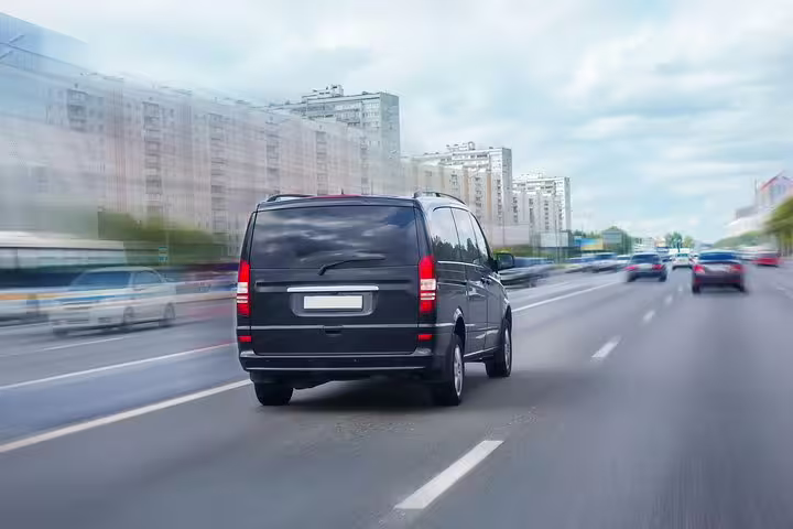 Luxury van speeding on highway for efficient private transfers from Treviso Canova Airport to Piazzale Roma in Venice.