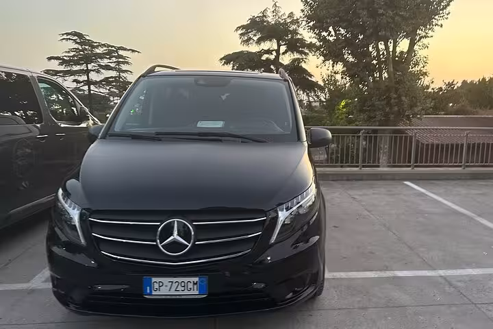 Sleek black luxury vehicle parked, ready for private transfer service from Rome to the scenic Amalfi Coast.