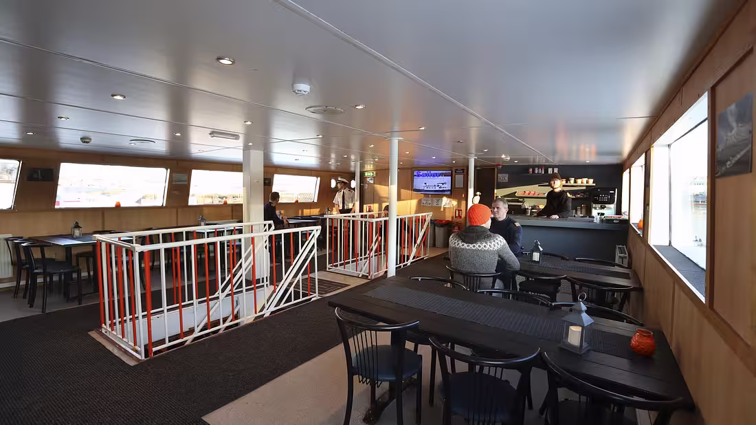 Inside of a luxury vessel with seating and bar area