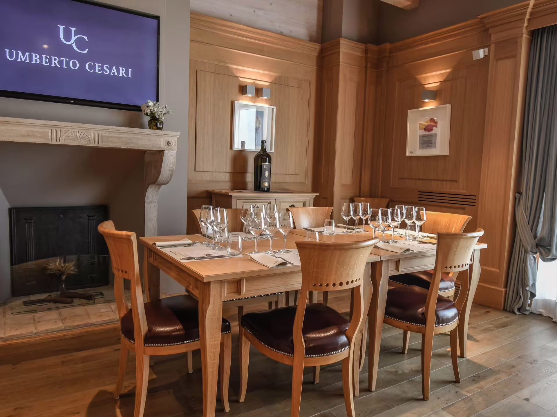 Cozy tasting room setup with wooden furniture and wine glasses, ideal for intimate wine pairing near Bologna.