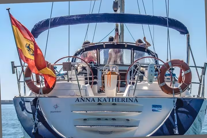 Rear view of luxury yacht with Spanish flag, perfect for a private Barcelona sailing tour with skipper, max 12 people