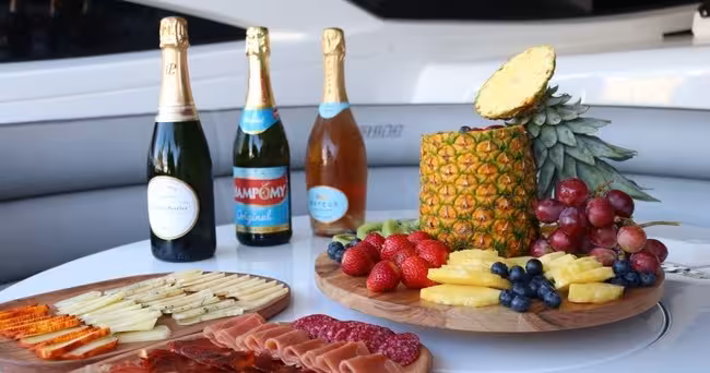 Gourmet fruit, cheese and charcuterie platters with chilled champagne on board an Xclusive Private Luxury Yacht charter