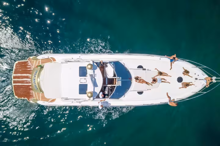 Aerial view of luxury yacht with guests sunbathing on an 8-hour Full Day Cruise Silver on turquoise sea