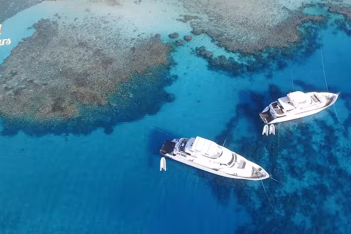 Aerial view of luxury yachts over turquoise reef on private boat trip from Hurghada to Sahl Hasheesh and El Gouna