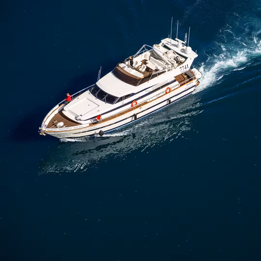 Aerial view of a luxury cruise yacht sailing arctic waters on an exclusive Northern Lights cruise adventure.