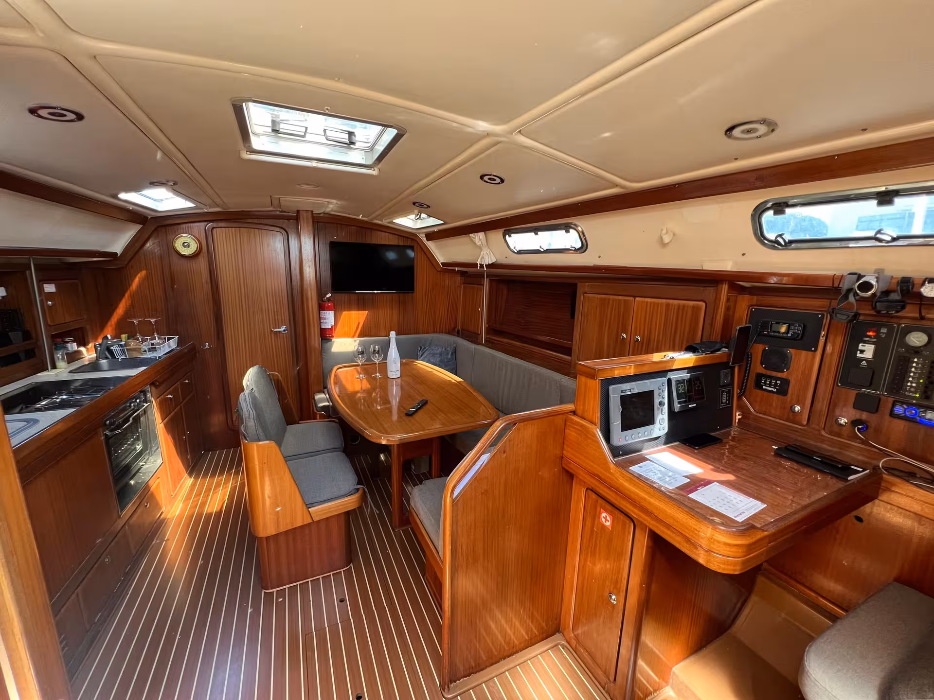 Luxury yacht salon with dining table and navigation station for a full-day Lagos yacht cruise adventure