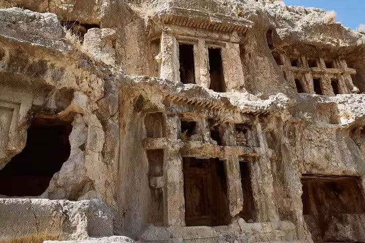 Ancient Lycian rock tombs at Tlos, showcasing historical architecture on a guided tour from Fethiye.