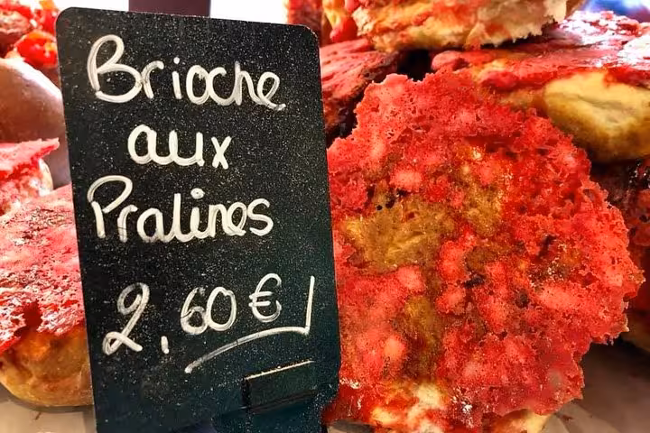 Close-up of Brioche aux Pralines with a price tag, highlighting Lyon's culinary delights on a private food tour.