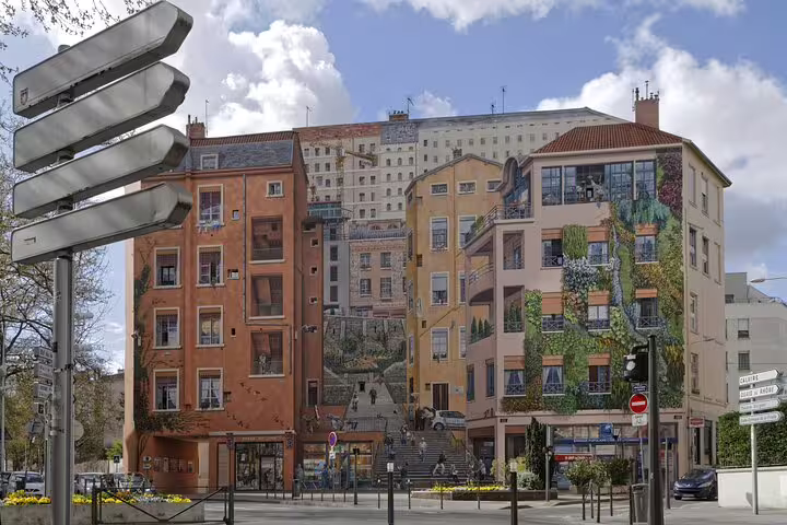 Colorful trompe-l'oeil mural on building facades in Lyon's Croix-Rousse neighborhood