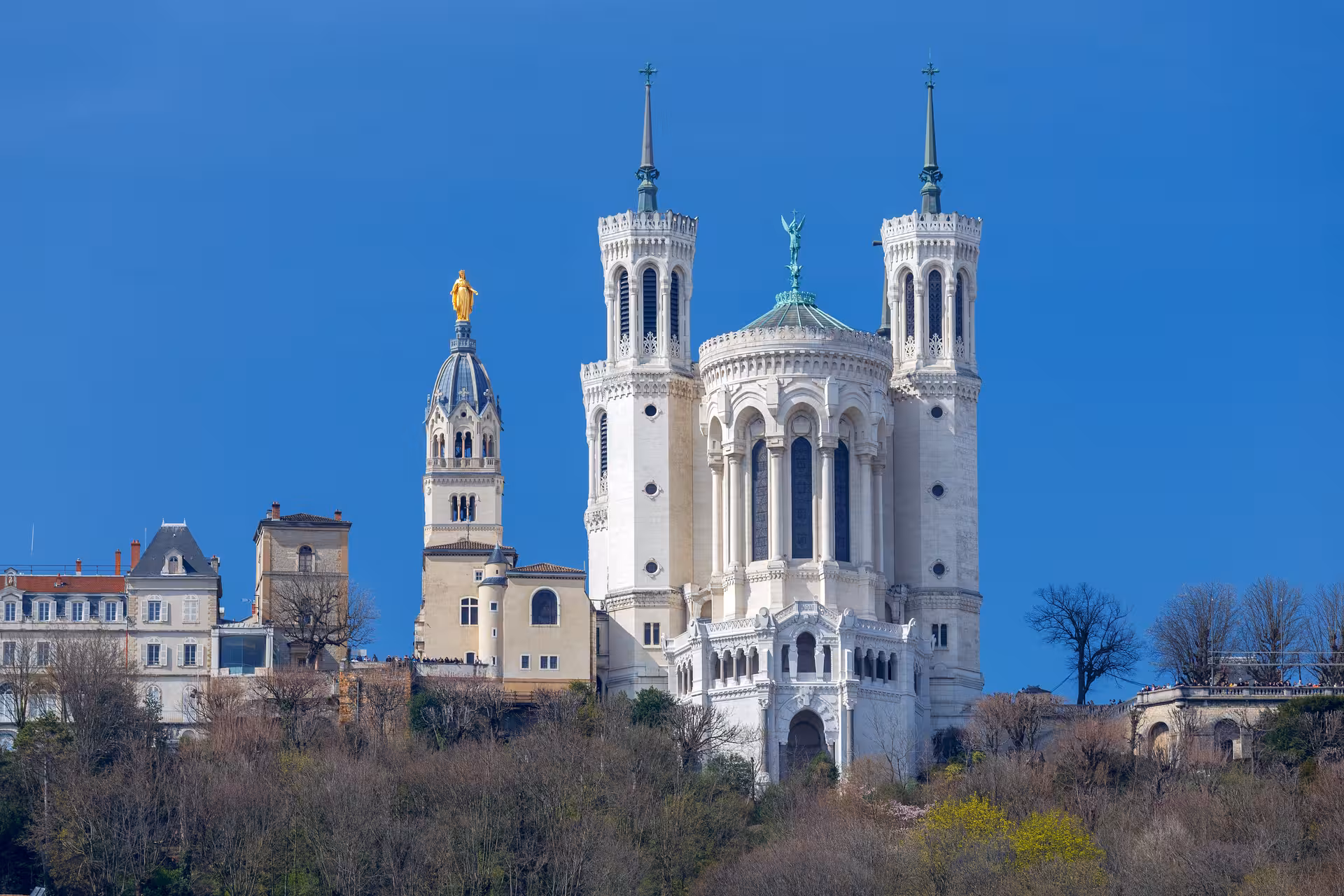 Basilica of Notre-Dame de Fourvière with golden Virgin Mary statue atop Fourvière Hill in Lyon, France