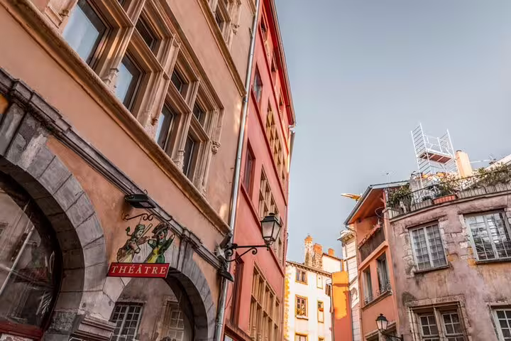 Colorful historic buildings and theatre sign in Lyon Old Town narrow street