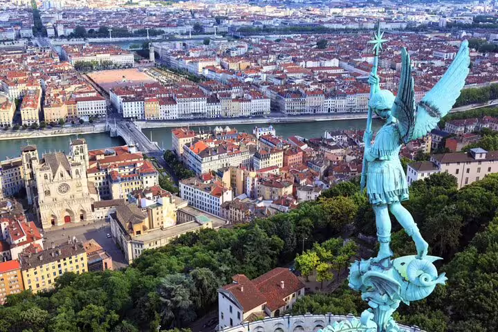 Aerial view of Lyon city with Saint Michael statue and Saône River from Fourvière hill