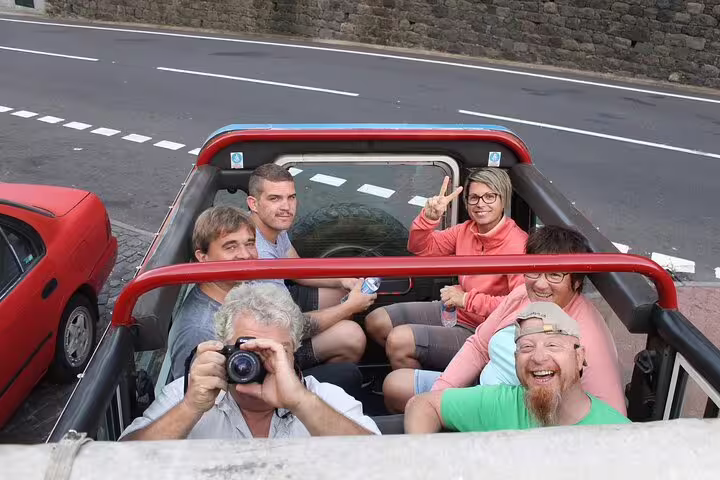Group of tourists enjoying a scenic 4x4 adventure through Madeira's stunning landscapes, capturing memories and smiles.