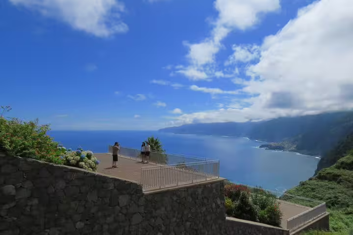 Scenic coastal view from Madeira 4x4 tour showcasing lush landscapes and expansive ocean vistas under a vibrant blue sky.